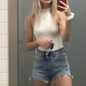 Sleeveless white turtleneck